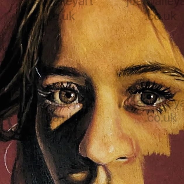 A close up of a young woman with detail in the eyes and good use of shade and shadows.